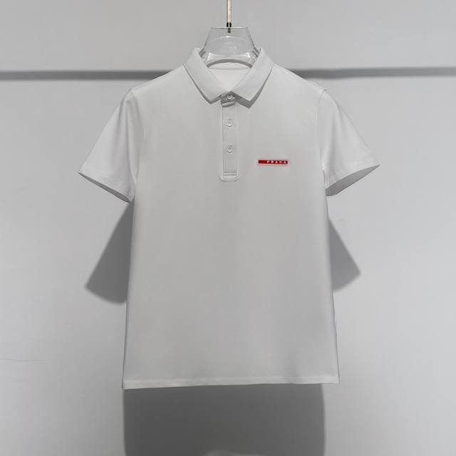 24新品 Prada 普拉达刺绣polo衫，黑、白色，M- L 来自意大利知名的奢侈品牌。其独特天赋在于对新创意的不懈追求，不仅能够预测时尚趋势,更能够引领时尚